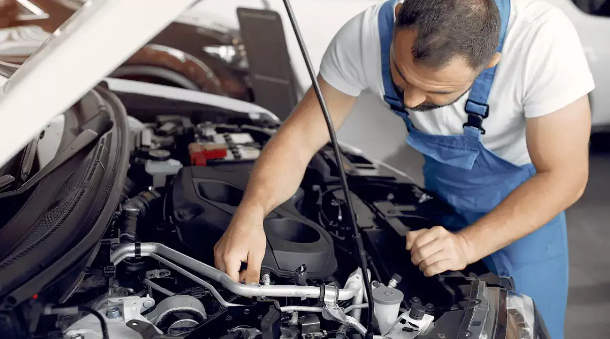 mechanic repairing a car's engine